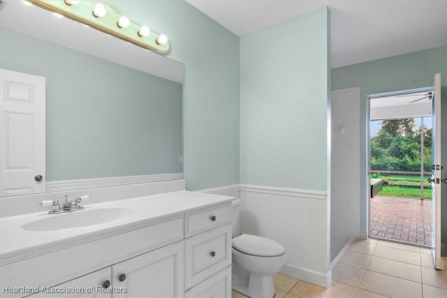 bathroom with tile patterned flooring, vanity, and toilet