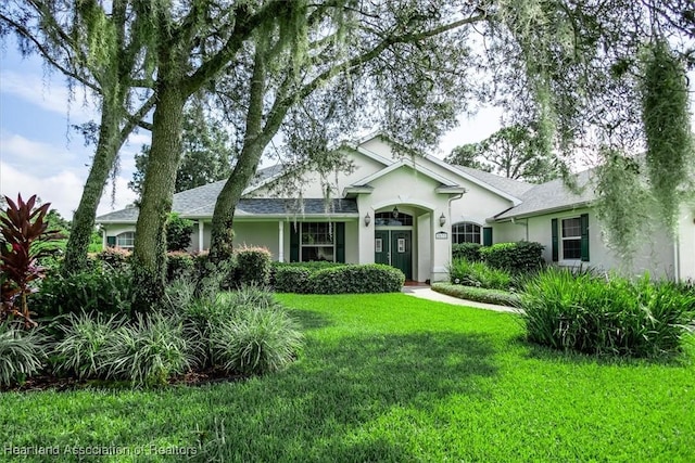 single story home featuring a front lawn