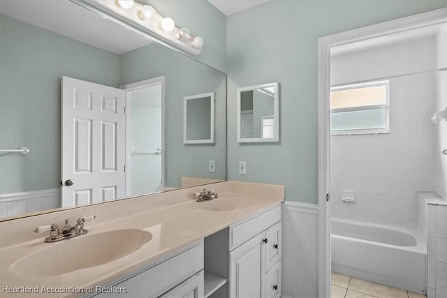 bathroom with tile patterned floors, vanity, and bathing tub / shower combination