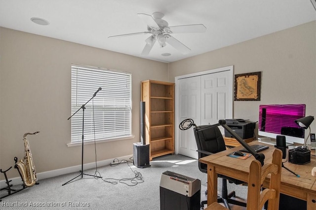 carpeted office with ceiling fan