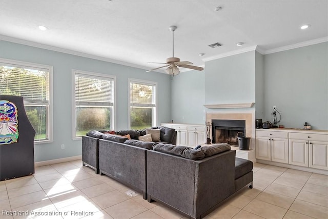 tiled living room with ceiling fan and ornamental molding