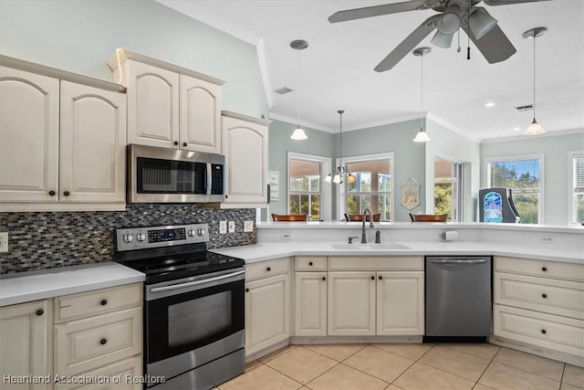 kitchen featuring decorative light fixtures, stainless steel appliances, tasteful backsplash, and sink