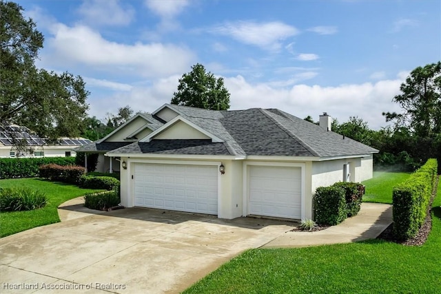 view of side of home featuring a lawn and a garage