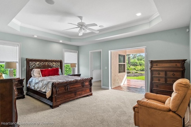 bedroom with a raised ceiling, access to exterior, ceiling fan, and light colored carpet