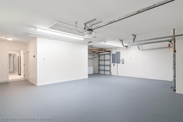 garage featuring electric panel and a garage door opener