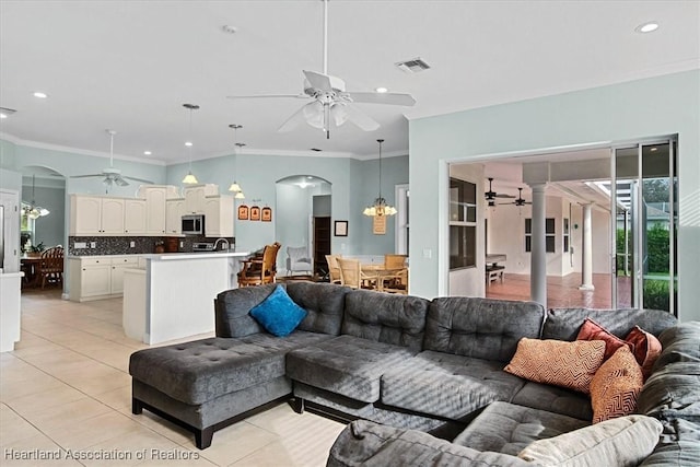 tiled living room with a notable chandelier and ornamental molding