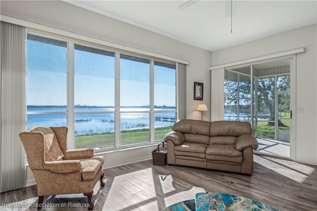 living room featuring a water view, plenty of natural light, and wood finished floors