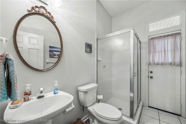 full bath with a sink, tile patterned floors, toilet, and a shower stall
