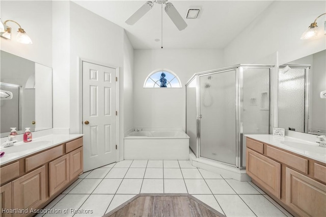 bathroom with ceiling fan, visible vents, a sink, and a stall shower