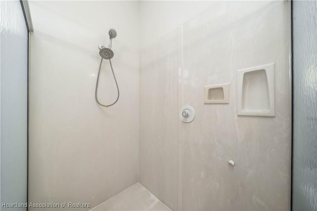 bathroom with tiled shower