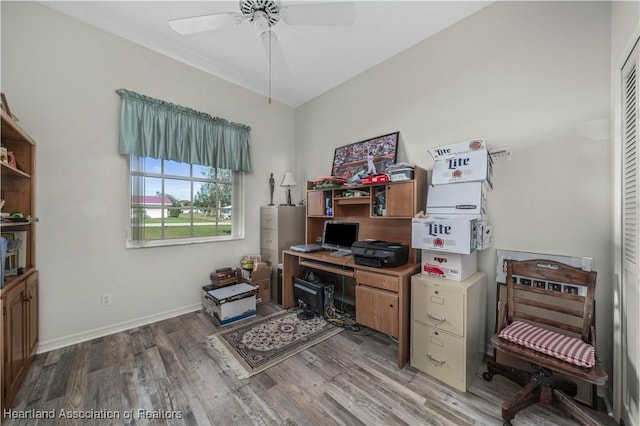 office space with baseboards, ceiling fan, and light wood-type flooring