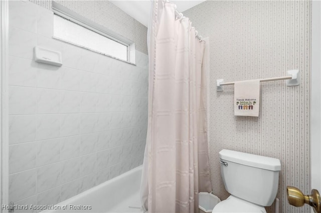 bathroom with shower / tub combo and toilet