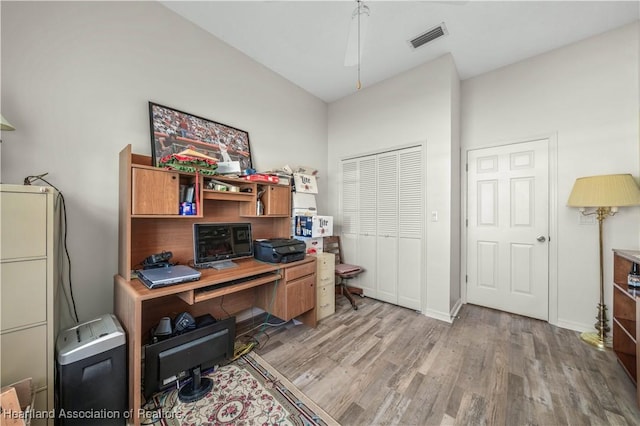 office space featuring light wood-style floors, baseboards, and visible vents