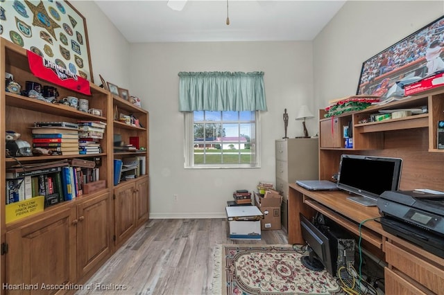office area featuring light wood-type flooring and baseboards