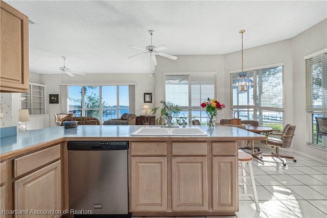 kitchen featuring light brown cabinets, a sink, ceiling fan with notable chandelier, and dishwasher