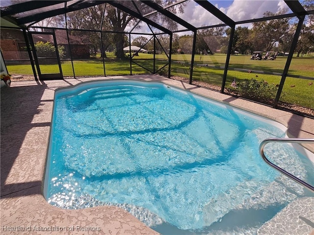 view of pool featuring a yard and a lanai