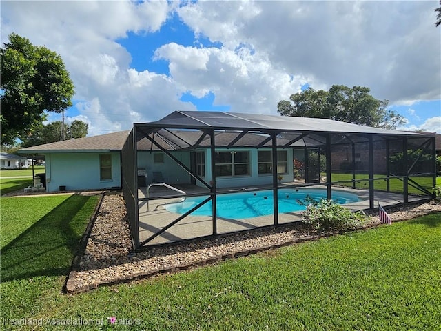 view of pool with a lanai, a yard, and a patio