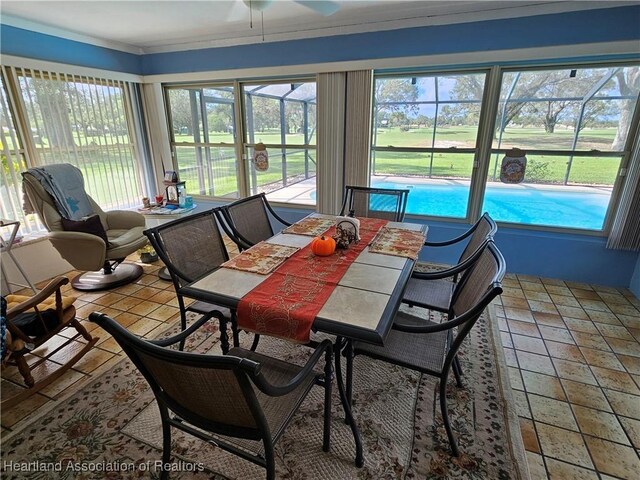 sunroom / solarium featuring ceiling fan and plenty of natural light