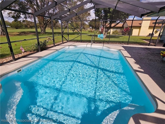 view of pool featuring a yard and a lanai