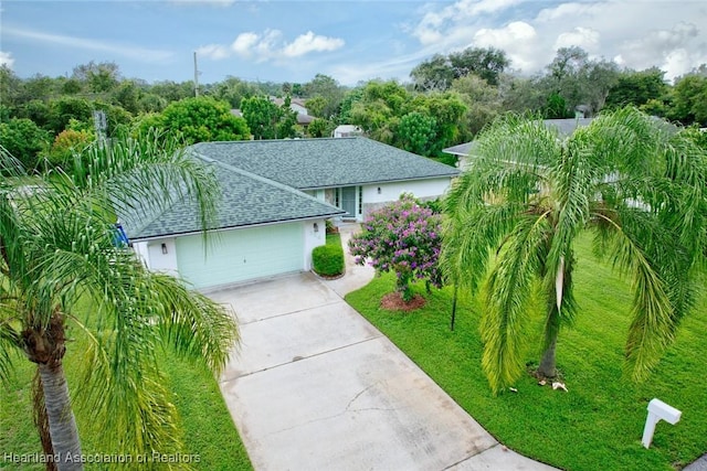 view of front facade featuring a garage and a front lawn