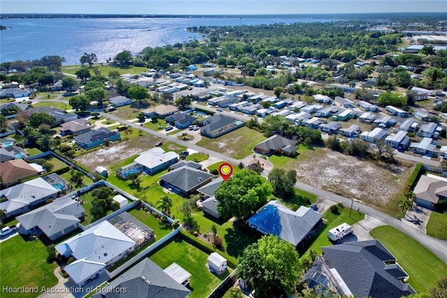 drone / aerial view featuring a residential view and a water view