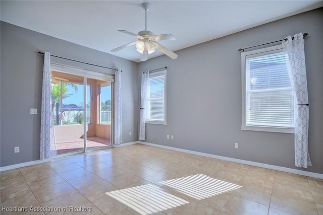 spare room featuring baseboards, ceiling fan, and tile patterned flooring