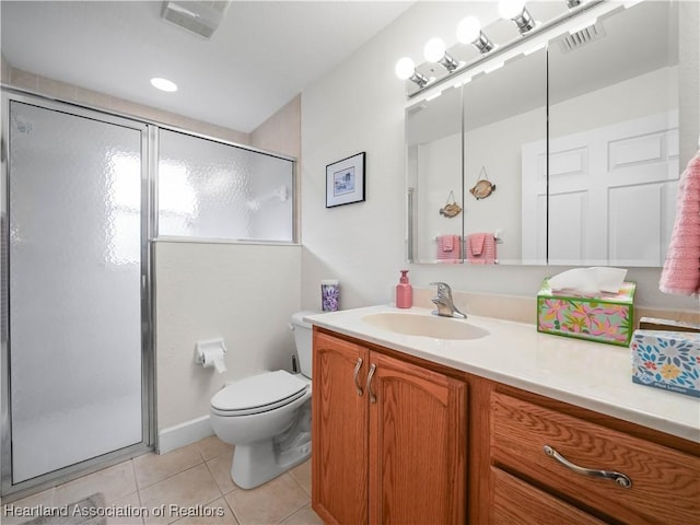 bathroom with toilet, vanity, tile patterned floors, and a shower with shower door