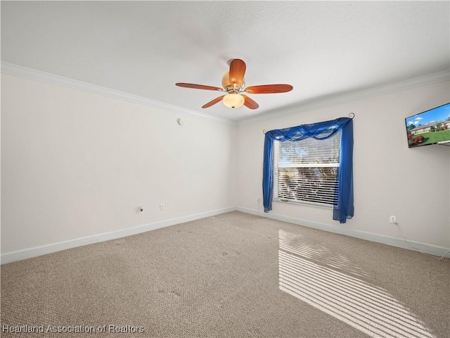 unfurnished room featuring carpet, ceiling fan, and crown molding