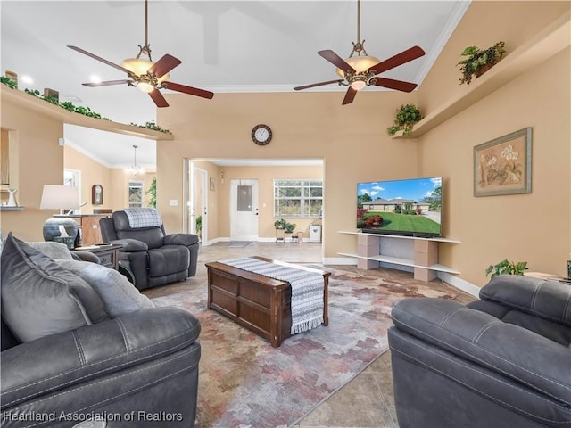 living room with crown molding, ceiling fan, and a high ceiling