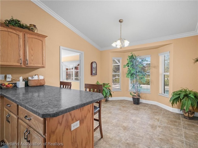 kitchen featuring pendant lighting, an inviting chandelier, vaulted ceiling, and ornamental molding