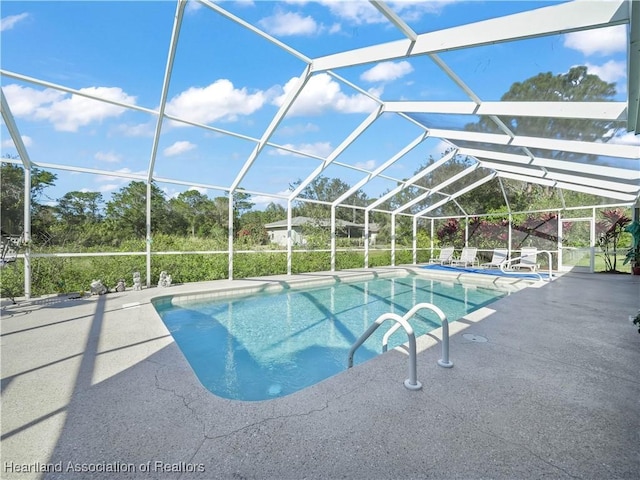 view of pool featuring a patio area and a lanai