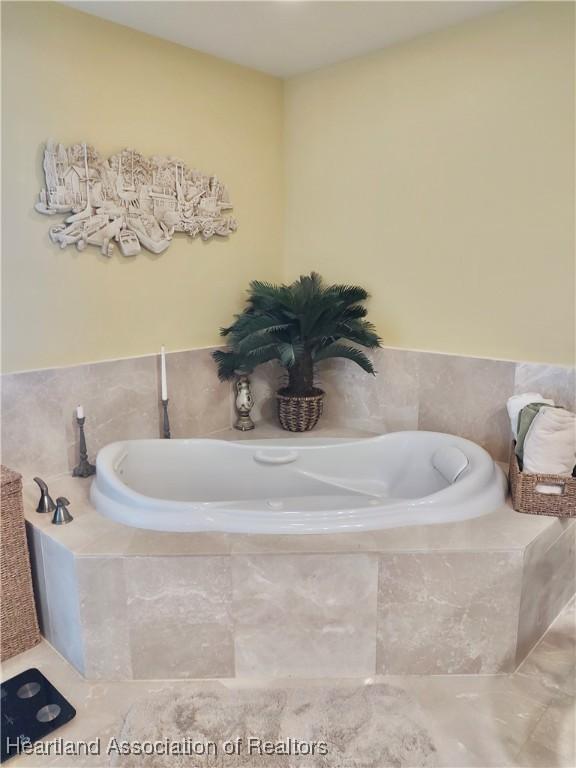 bathroom featuring a relaxing tiled tub