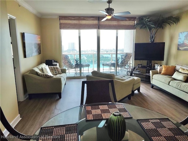 living room featuring ceiling fan, wood-type flooring, and crown molding