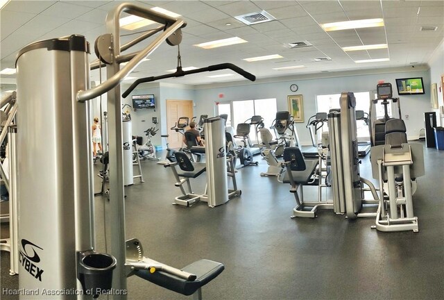 gym with a paneled ceiling