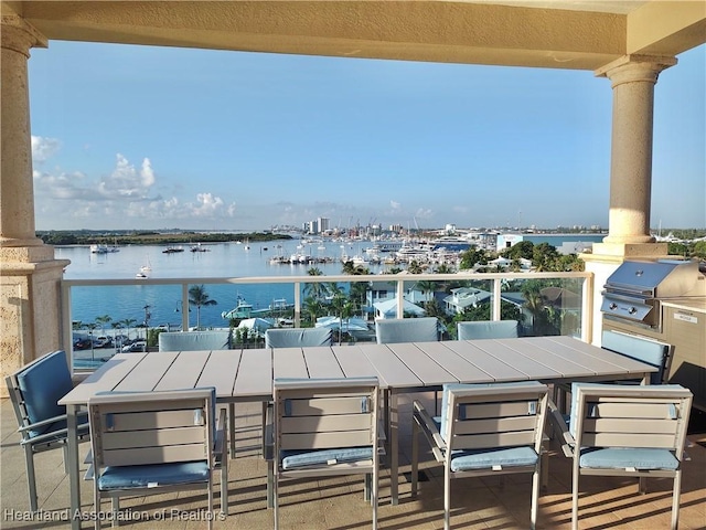 balcony featuring a grill and a water view