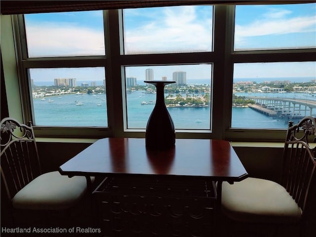 dining area featuring a wealth of natural light and a water view