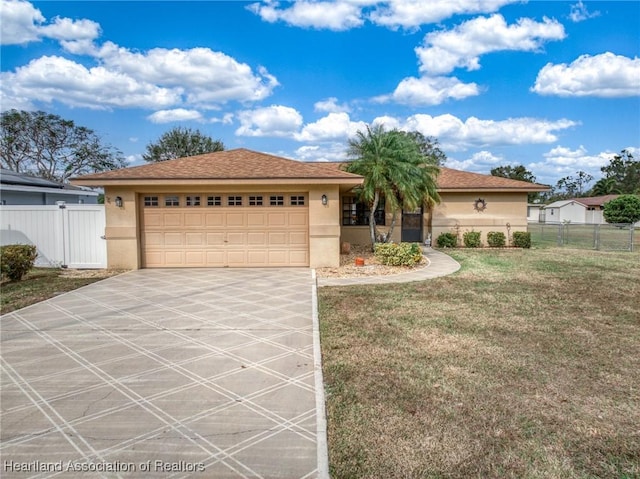 view of front of home featuring a garage and a front lawn