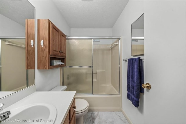 full bathroom featuring vanity, a textured ceiling, toilet, and bath / shower combo with glass door