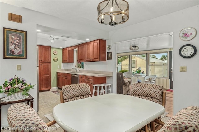 dining area with ceiling fan with notable chandelier