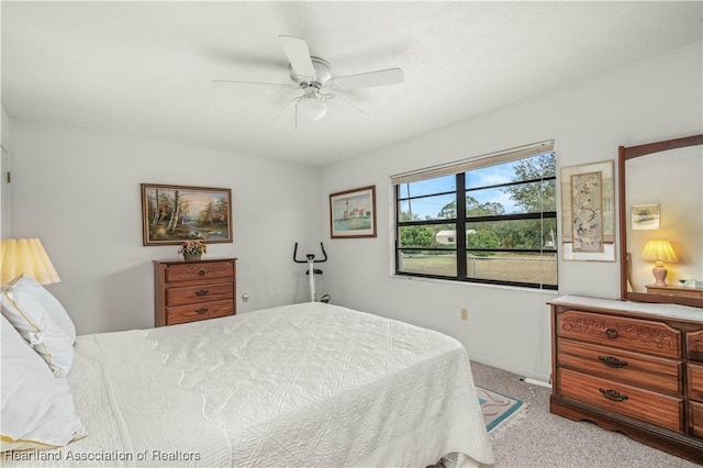 bedroom with ceiling fan and light colored carpet