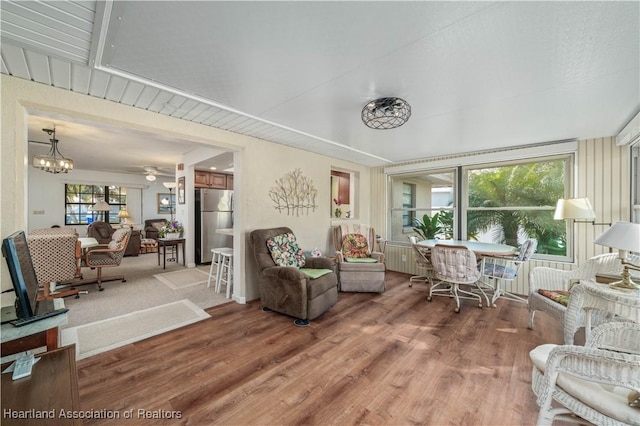 sunroom / solarium featuring ceiling fan with notable chandelier and plenty of natural light