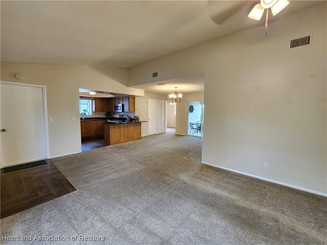 4101 Elson Ave, Sebring, FL 33875 - unfurnished living room with dark colored carpet, a chandelier, and a ceiling fan