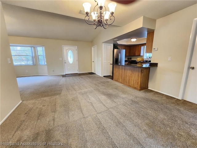 4101 Elson Ave, Sebring, FL 33875 - kitchen featuring stainless steel fridge, carpet floors, a chandelier, dark countertops, and open floor plan