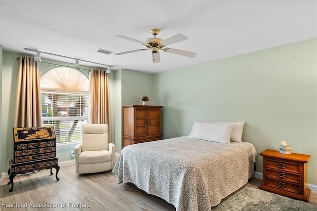 bedroom with light hardwood / wood-style floors and ceiling fan