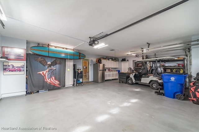 garage featuring a garage door opener and stainless steel refrigerator