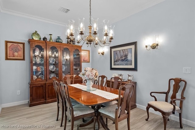 dining space featuring a notable chandelier, crown molding, and light hardwood / wood-style flooring