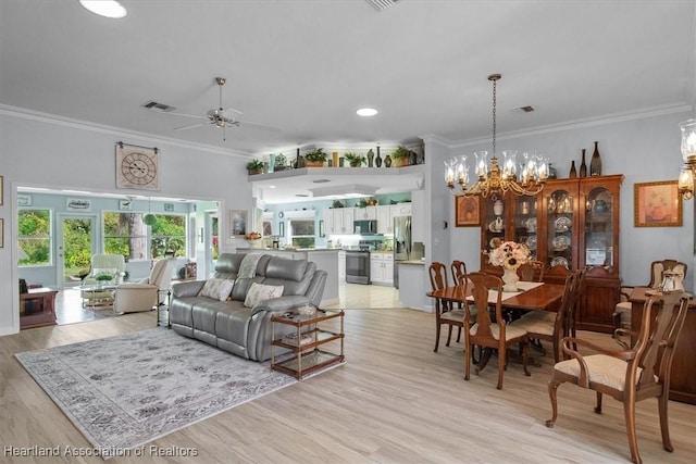 living room with ceiling fan with notable chandelier, light hardwood / wood-style flooring, and crown molding