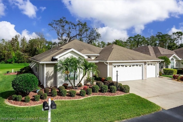 view of front facade featuring a front yard and a garage