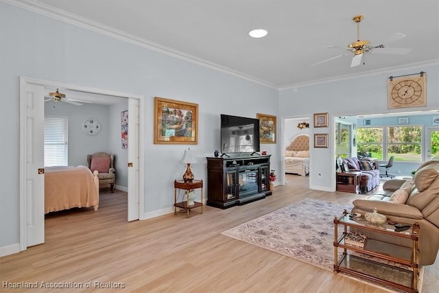 living room with ceiling fan, light hardwood / wood-style flooring, and ornamental molding