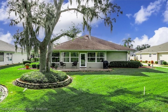 back of house with a yard and a patio